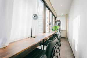 a long table in a room with chairs at unito light SHIMBASHI in Tokyo