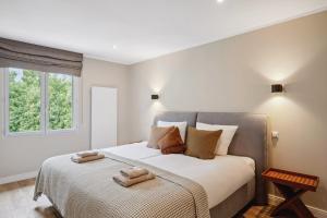 a bedroom with a bed with two towels on it at Villa Lavyn in Grimaud +60 photos