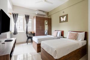 a hotel room with two beds and a desk at Wandr Hotel Brookefield, Bangalore in Bangalore +33 photos