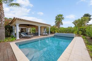 a swimming pool in the backyard of a house at Villa Lavyn in Grimaud