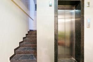 a staircase with a metal elevator in a building at Wandr Hotel Brookefield, Bangalore in Bengaluru