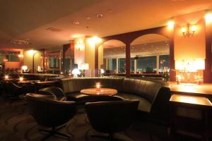 a restaurant with couches and tables and a bar at Hotel Nikko Narita in Narita