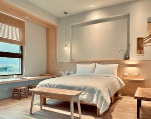Postel nebo postele na pokoji v ubytování 不想上班 宜蘭民宿-Don't Wanna Work B&B