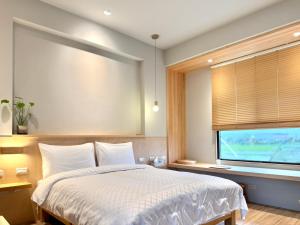 Postel nebo postele na pokoji v ubytování 不想上班 宜蘭民宿-Don't Wanna Work B&B