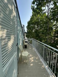 a balcony with two chairs and a fence at Hotel Ginevra e Residence in Cattolica