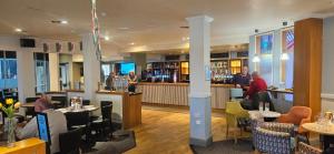 a restaurant with people sitting at tables and a bar at Gull Court 3 Double Bed Caravan in Tremadoc