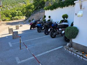 a row of motorcycles parked next to a building at Apartmens Mendula in Senj