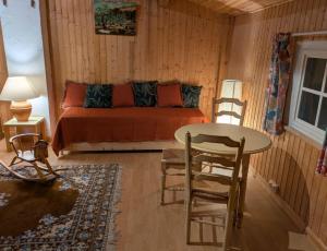 a bedroom with a bed and a table and chairs at Le Relais Laviolette in Cruis