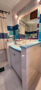 a bathroom with a sink and a large mirror at Tertium Home in Telti +13 photos