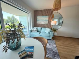 un soggiorno con un divano e un tavolo di Helikon Beach Apartment a Keszthely