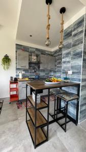 a kitchen with a wooden table and a counter at Koru House Torvaianica in Torvaianica