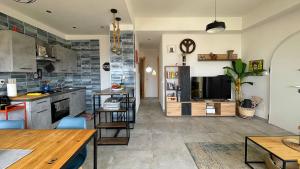 a kitchen with a table and a dining room at Koru House Torvaianica in Torvaianica +45 photos