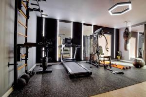 a room with a gym with a treadmill and weights at Villa Arthur in Kassiopi