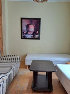 a living room with a couch and a table at Basanavičiaus kampelis in Palanga