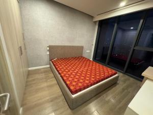 a bed in a room with a large window at Sweet Home in Kon Rung (1)