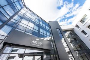 an office building with an art nm sign on it at AIRINN Vilnius Airport Hotel RENOVATED 2025 in Vilnius +30 photos