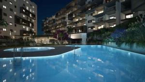 an empty swimming pool in front of a building at Casa Catalina - breathtaking sea views by OYOOSTAYS in Dehesa de Campoamor