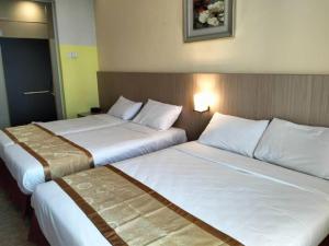 Postel nebo postele na pokoji v ubytování Seeds Hotel Kuala Selangor