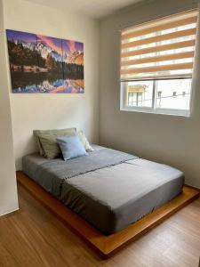 Postel nebo postele na pokoji v ubytování Studio Apartment with Balcony at East Residences Ortigas + 5 fotografií