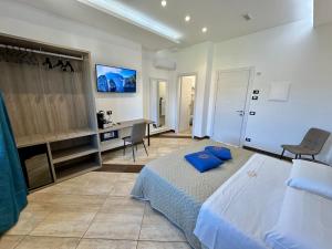 a bedroom with a bed and a desk in it at La Maison Du Soleil Rooms in Agerola +38 photos