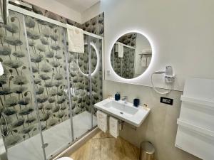 a bathroom with a shower and a sink and a mirror at La Maison Du Soleil Rooms in Agerola