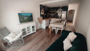 a living room with a couch and a tv and a table at La fulla verda in San Martín de Tous