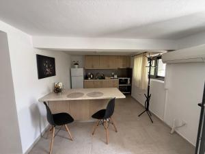 a kitchen with a large island in the middle of a room at Eleousa Cozy Apartment in Eleoúsa