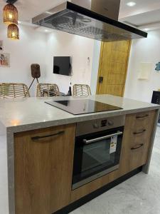 a kitchen with a counter with a stove top oven at Luxury 2 bedrooms apartment in kantaoui in Bin Rhilouf +7 photos