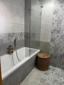 a bathroom with a bath tub and a shower at Luxury 2 bedrooms apartment in kantaoui in Bin Rhilouf