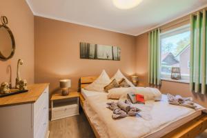 a bedroom with a large bed and a window at Ferienhaus Hünzingen in Walsrode