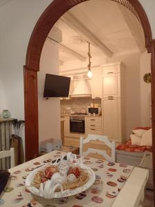 a kitchen with a table with a plate of food on it at Dimora Egnazia in Savelletri di Fasano +16 photos