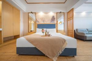 Gulta vai gultas numurā naktsmītnē Kuanyue Service Apartment Chongqing Lijia Children's Hospital Happy Valley Branch