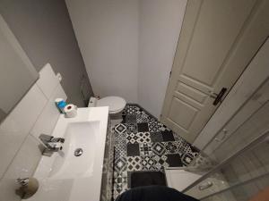 a small bathroom with a toilet and a sink at Jolie maison centre Ernée in Ernée