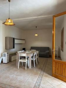 a kitchen and dining room with a table and chairs at Casa Margherita in Tre Fontane