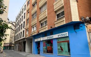 a blue building on a street in a city at Apartamentos Elysium in Córdoba