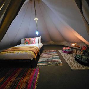 a room with a bed in a tent at Stone Circle Glamping in Durrington