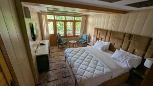 a bedroom with a bed and a table and chairs at The Jade Palace, Hunza in Karimabad Hunza