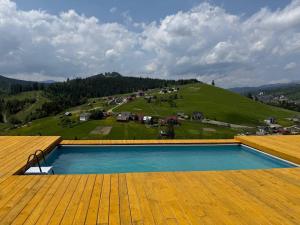 a swimming pool on the roof of a house at Карпати Плай Village in Bukovel