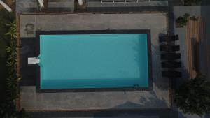 an overhead view of a swimming pool with a large screen tv at Nalluri Garden Resort in Kottapatnam