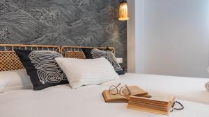 a bed with a pair of shoes and a book on it at Apartamento Balcón El Rincón by Ruralidays in Rincón de la Victoria +36 photos