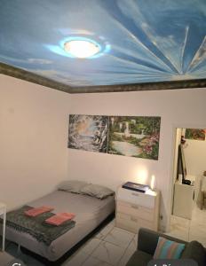 a bedroom with a bed with a blue ceiling at MONACO 3mn du casino in Beausoleil