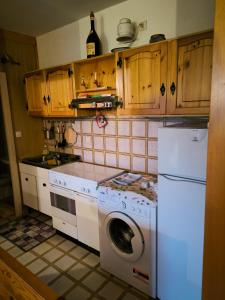 a kitchen with a washing machine and a washer at Appartamento Tonezza in Tonezza del Cimone