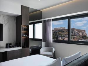 a hotel room with a bed and a window at Nur Edge Aparthotel - Acropolis Skyline in Athens
