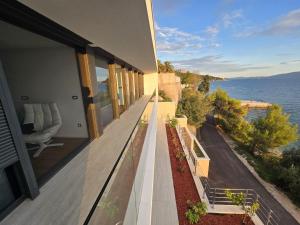 a house with a balcony with a view of the ocean at Villa Deluxe Zaostrog in Zaostrog +39 photos