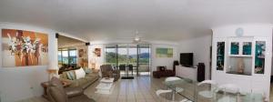 a living room with a couch and a table at Poinciana 112 in Hamilton Island