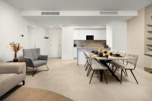 a dining room and kitchen with a table and chairs at Luxury 3bed-Apartment with Stunning Sea Views in Rincón de la Victoria