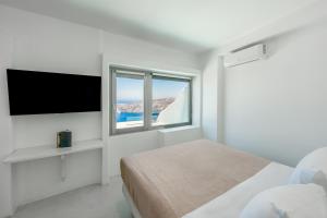A bed or beds in a room at Ilioperato Hotel