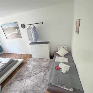 a white room with a bed and a table at Ferienwohnung in Göppingen +25 photos