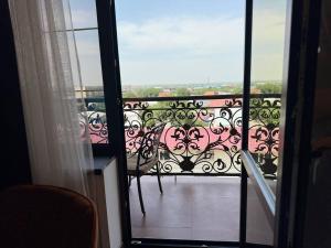 a view of a balcony with a bench on it at Hotel Madonna SPA in Qaskeleng