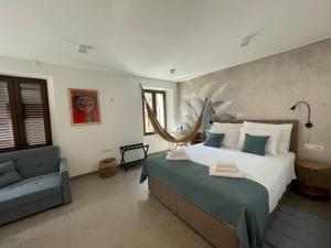 a bedroom with a large bed and a chair at Botique Studio - Casa El Sueño in Vodnjan